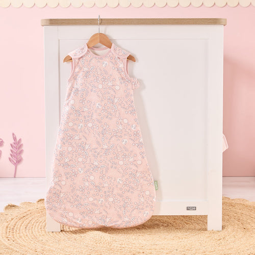 Tiny Tails baby sleep bag hanging in soft pink nursery, featuring calming woodland print for a serene and stylish bedtime look
