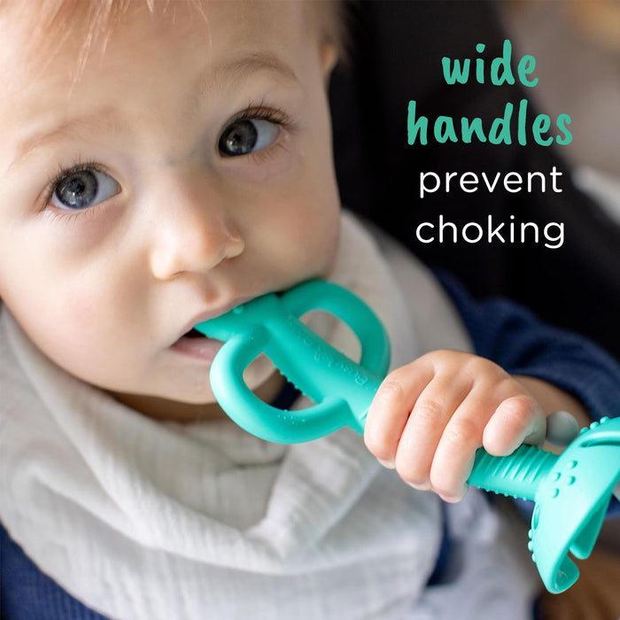 Baby chewing on a Busy Baby Teething Spoon with text that reads, "wide handles prevent choking"