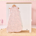 Tiny Tails baby sleep bag hanging in soft pink nursery, featuring calming woodland print for a serene and stylish bedtime look