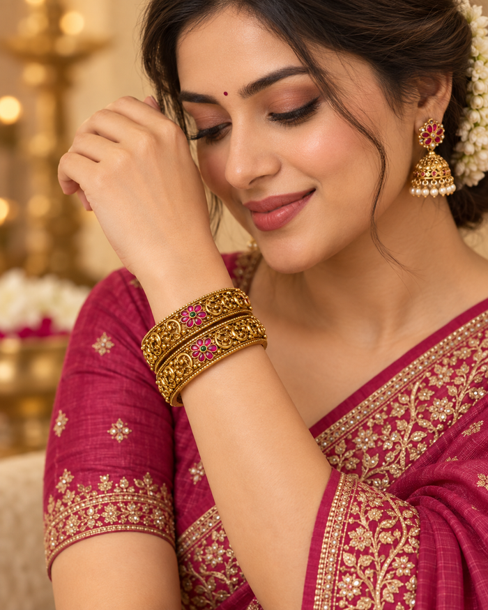 Antique gold floral kada bangles pair with pink and green stones