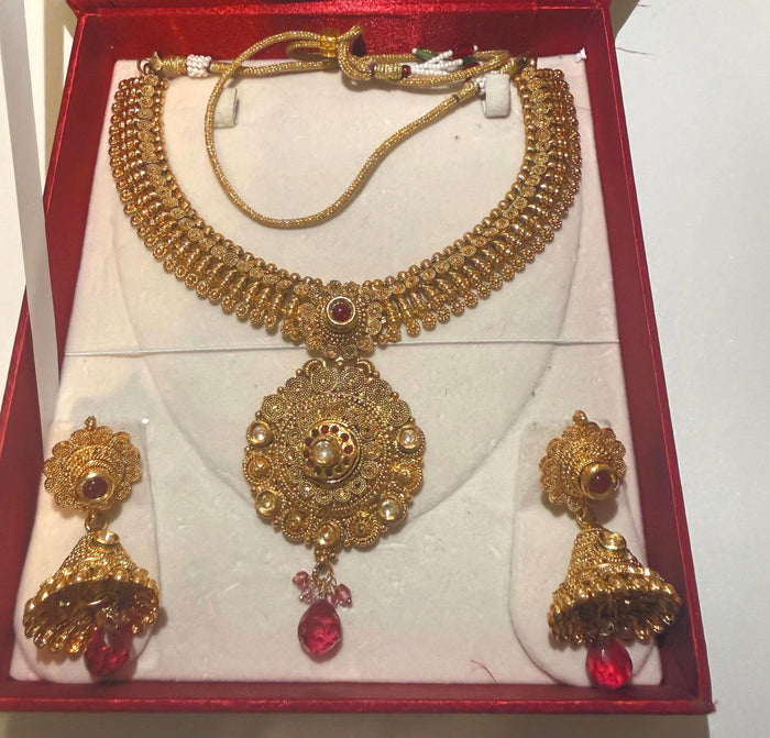 Antique gold temple-inspired necklace and jhumka set – filigree and red bead detail