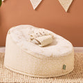 Love Cats baby beanbag in beige leopard print styled in a warm nursery space, featuring playful cat face harness and gentle support