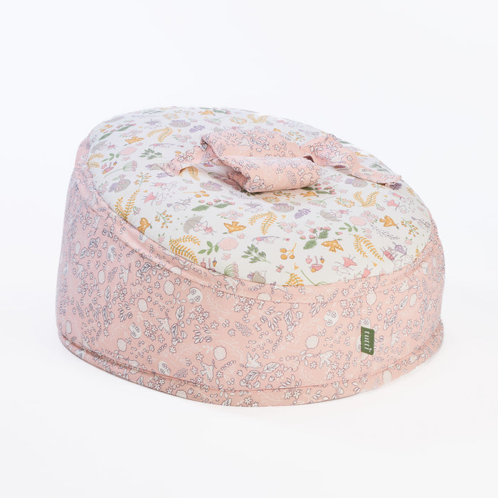 Cutout of Tiny Tails beanbag with attached harness in soft pink woodland print, designed for newborn comfort and gentle support