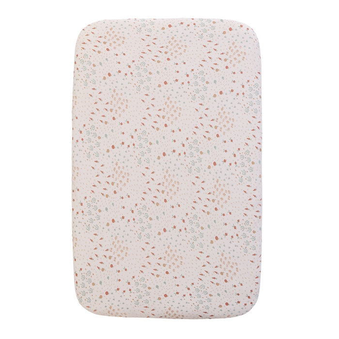A bedside crib fitted sheets with a nature-inspired scatter print featuring tiny carrots, soft florals and subtle dotted details, on a white background