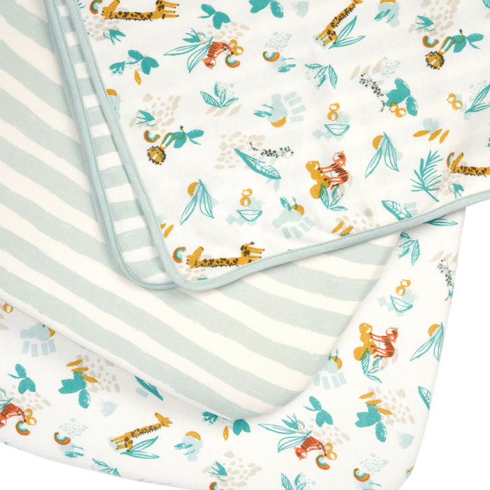 Run Wild bedside crib starter pack with fitted sheets and reversible coverlet, organic cotton featuring colourful jungle animal prints