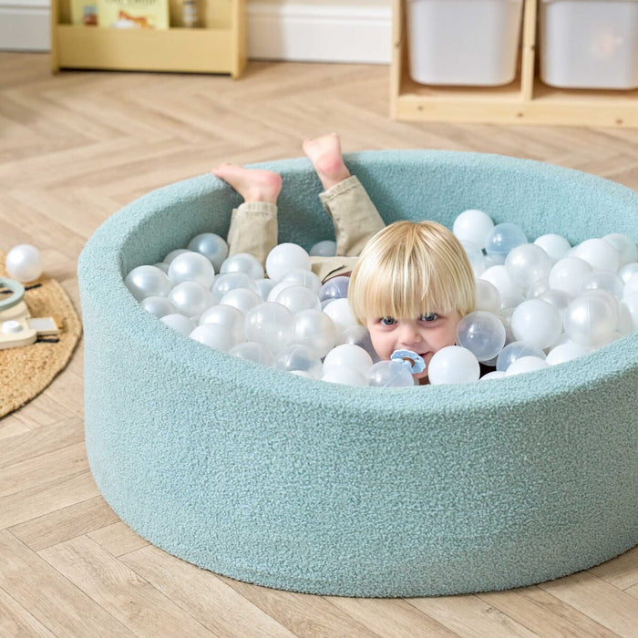 Bola Baby Ball Pit in Ocean Stone - lifestyle image of little boy playing in the ball pit