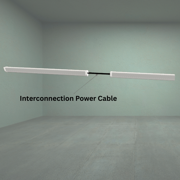 Two rectangular Boost LED lights from TAS are daisy chained together using the Boost and Infinity Power Interconnection Cable, suspended in a bare room with a label pointing to the cable.