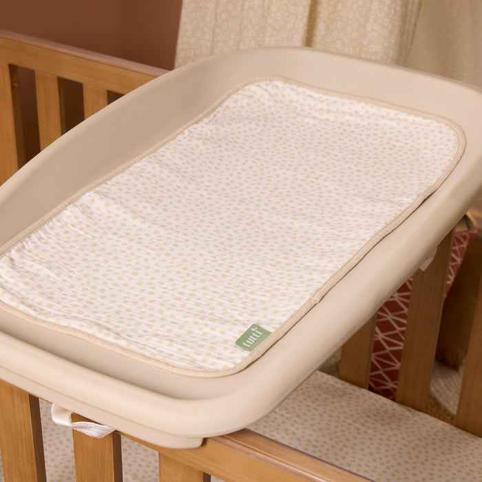 Love Cats beige changing mat liner on top of beige Cushi cot top changer