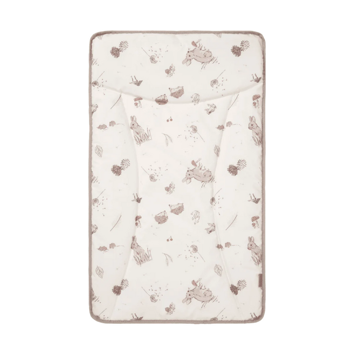 A beige changing mat with a woodland animal pattern including small illustrations of rabbits and leaves.