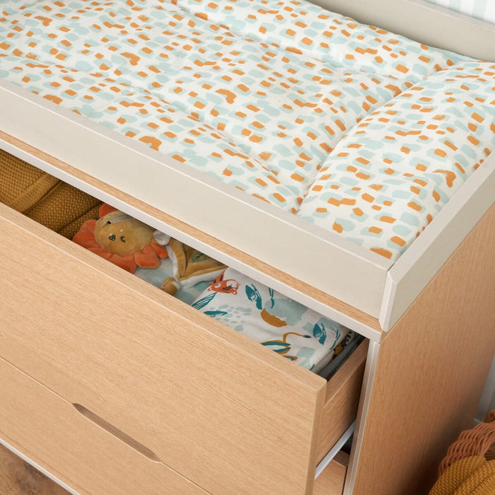 Detail of Fika chest changer in light oak showing changer space with leopard changing mat and interior of drawer