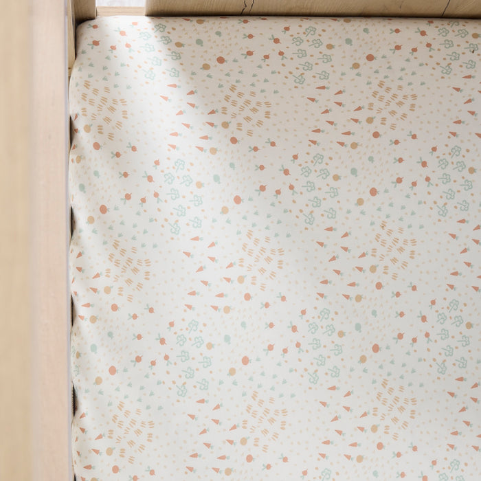 Farm-patterned fitted sheet from the Good Life on a bed corner