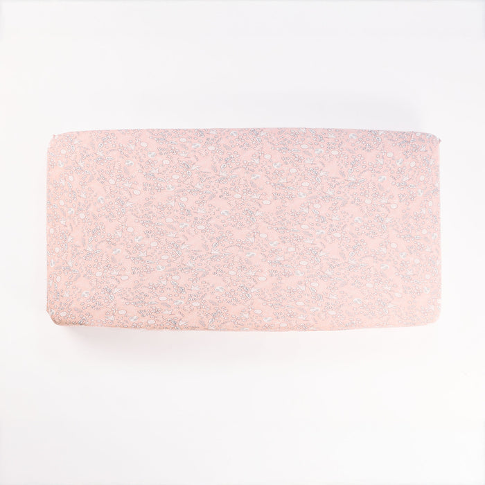 Tiny Tails cot fitted sheet laid flat on white background, highlighting detailed botanical pattern and soft cotton finish.