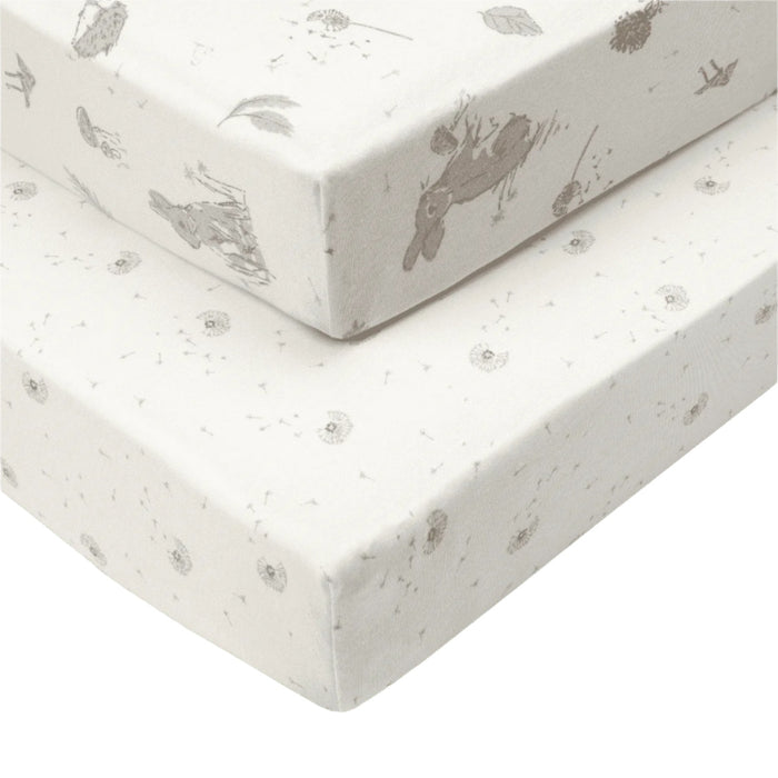 Cutout of Cocoon cot bed fitted sheets, one with woodland rabbit print and one neutral dotted, both crafted in organic cotton for breathable comfort