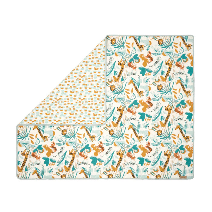Folded corner cutout of Run Wild coverlet, reversible quilted cotton with animal-themed prints adding warmth and vibrant design