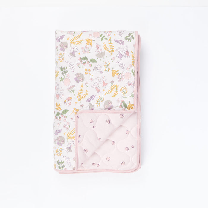 Cutout view of Tiny Tails cot bed coverlet showing reversible storybook mouse print and pink strawberry pattern in soft pastel tones