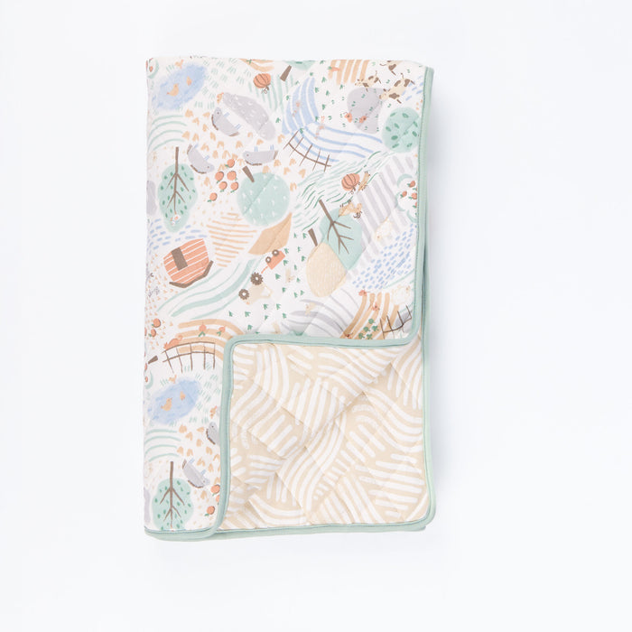 Cutout view of the Good Life cot bed coverlet with reversible woodland and countryside inspired print