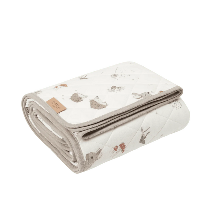 Folded cutout of Cocoon coverlet, quilted in soft cotton with neutral woodland animal prints for versatile comfort and style