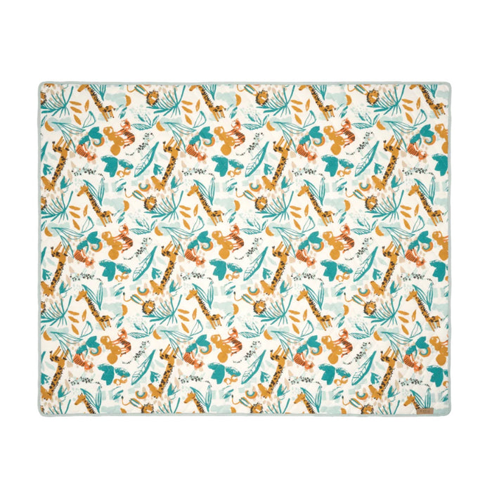 Flat lay of the Run Wild cot and cot bed coverlet featuring playful giraffe, tiger, and jungle leaf print