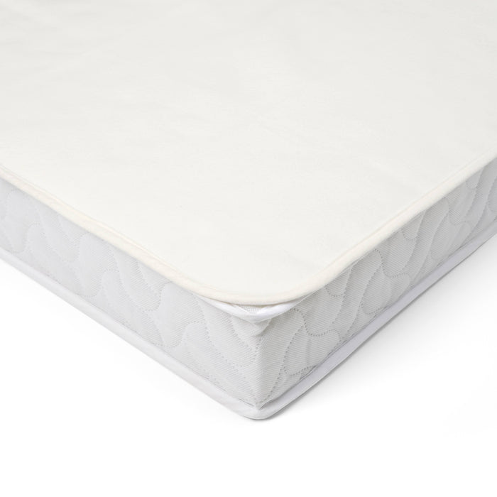Corner close-up of the waterproof cotton mattress protector for cot or cot bed, showing plush quilted surface and secure edge stitching