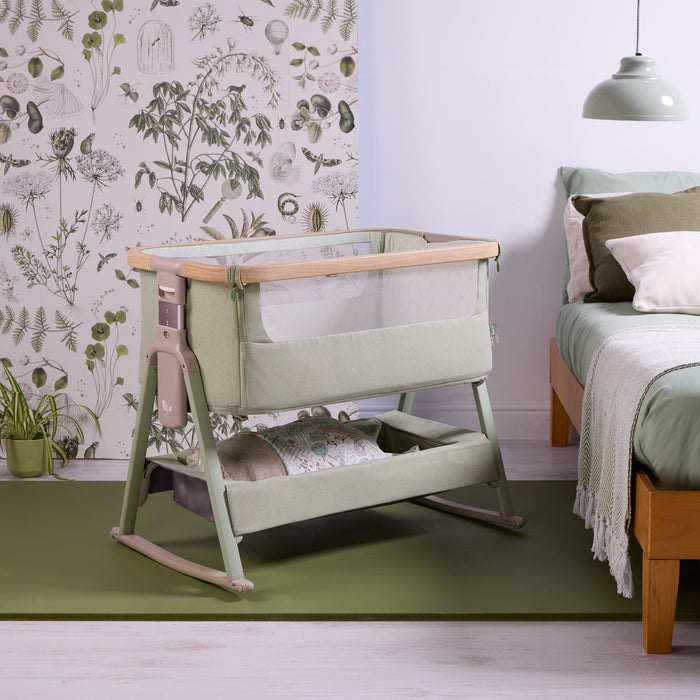 Angled view of the CoZee Air 2 bedside crib in eucalyptus, showing breathable mesh sides, wooden-effect frame and calming bedroom styling.