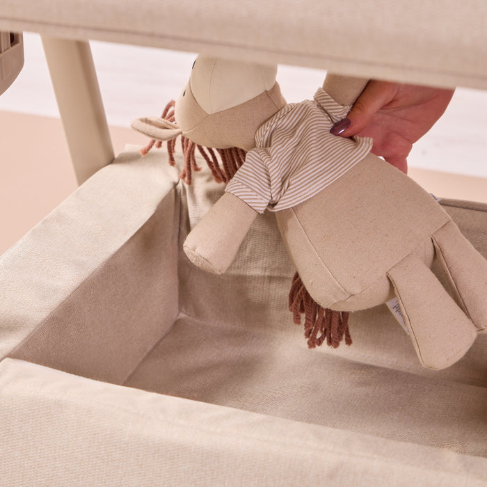 Close-up of the CoZee Air 2 in cocoa showing the lower storage shelf, ideal for keeping toys and baby essentials within easy reach.