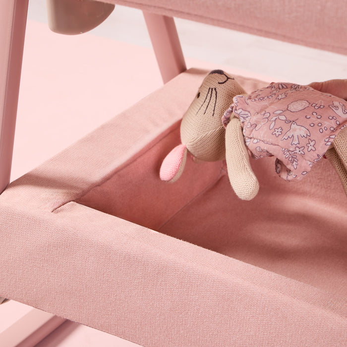 cozee air 2 in blush showing toy being placed in the spacious underneath storage