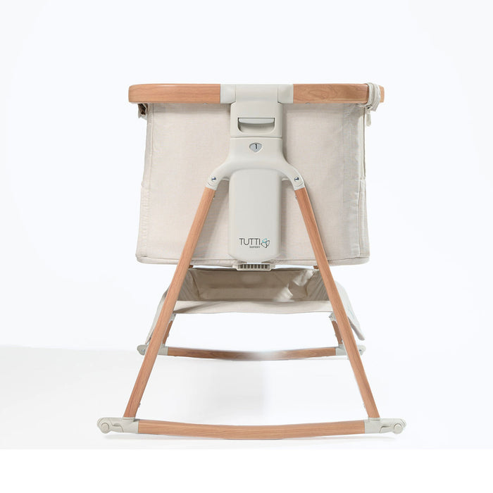 Side cutout view of the CoZee Air bedside crib in Scandinavian walnut and ecru, highlighting breathable fabric sides and solid rocking legs.