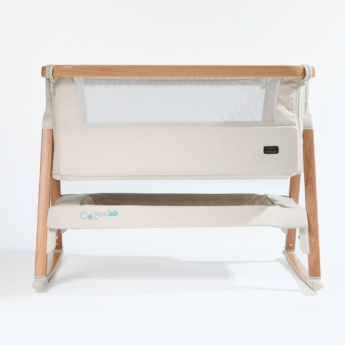 CoZee Air Bedside Crib in Scandinavian Walnut and Ecru – front cutout showing mesh side panel and oak-effect frame and rocking bars