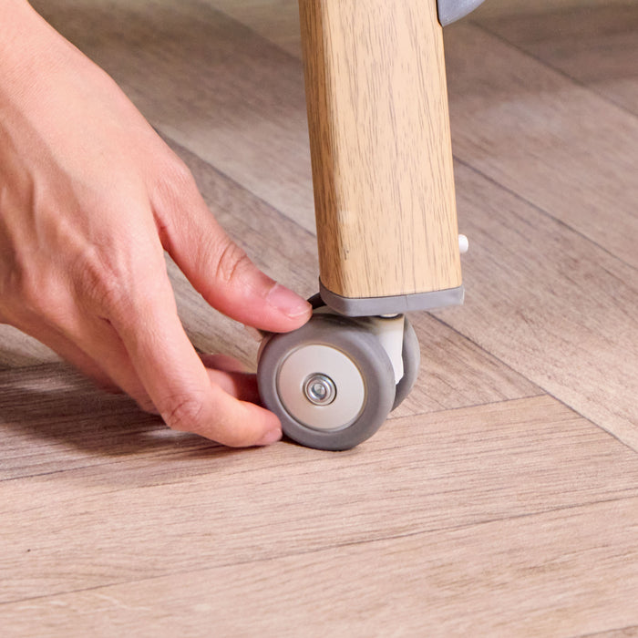 Lockable castors on CoZee Air Bedside Crib in Oak and Charcoal – smooth mobility and easy room-to-room movement