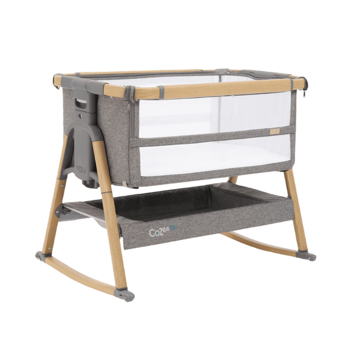Cutout view of the CoZee bedside crib in oak and charcoal with rocking bars connected, showcasing breathable mesh sides and sleek design
