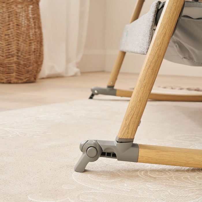 Close-up of the CoZee rocking bars in oak showing anti-rocking stabilisers for enhanced crib stability during stationary mode