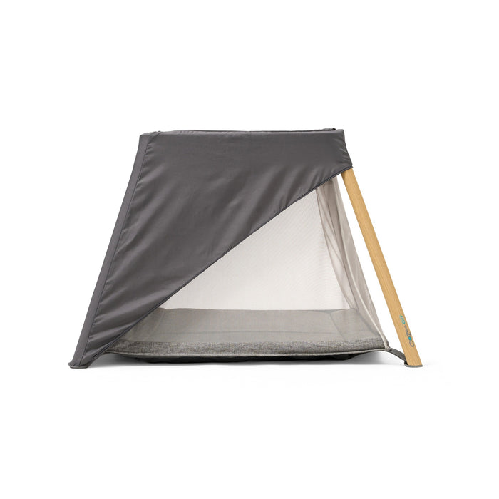 CoZee Go 3-in-1 Travel Cot – Side view with partial day and night shade coverage for adjustable light control