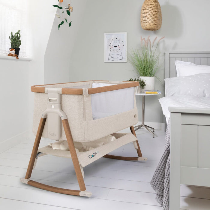 Styled bedroom view of the CoZee Air bedside crib in Scandinavian walnut and ecru with breathable mesh sides and under-storage shelf
