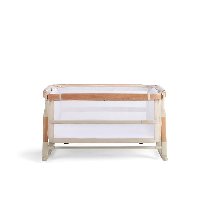 Cutout view of the CoZee bassinet in Scandi finish, shown in rocking mode with mesh panels and curved legs for gentle soothing