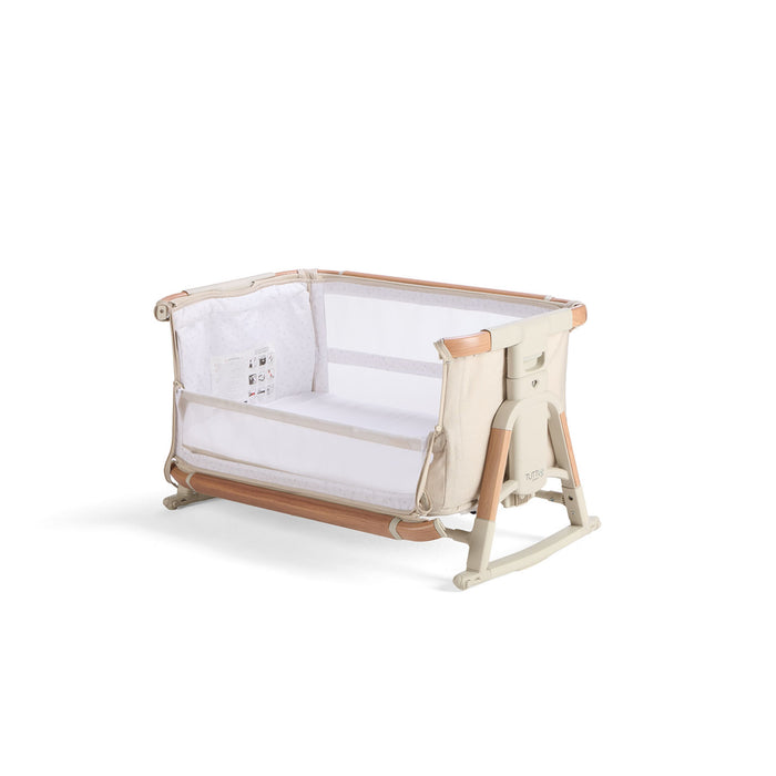 Angled cutout of the CoZee Scandi bassinet in side-down mode, highlighting breathable mesh panels and compact frame