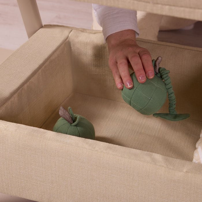 Under-crib storage basket on the CoZee Zen in sand, styled with soft toys for practical everyday storage.