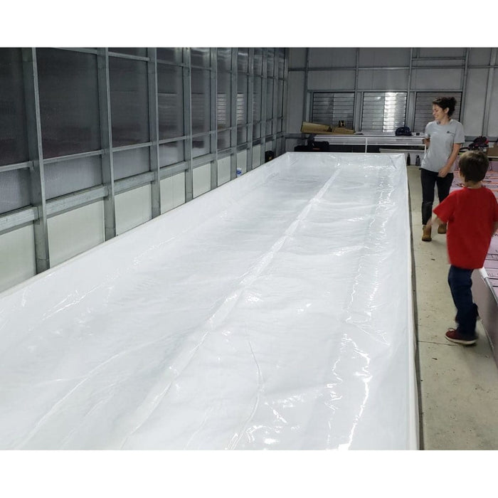 Two people standing in front of a large Aquaponics For Life Dura-Skrim Liner – 6′ Width.