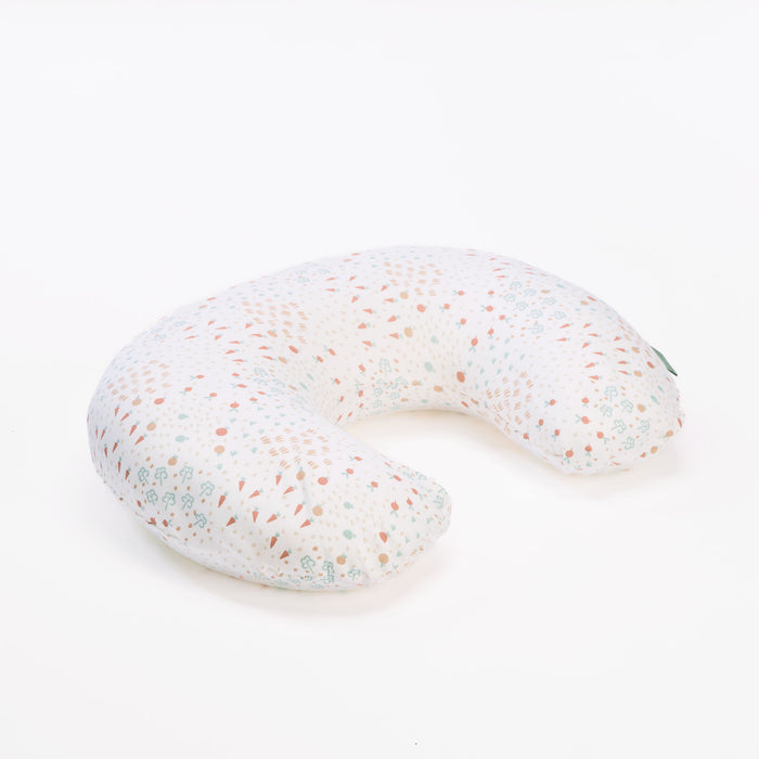 Good Life feeding pillow in white with scattered pastel print, shown in cutout view highlighting its curved, supportive nursing shape.