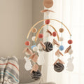 A decorative baby mobile with various felt animals and Embroidery appliques in a woodland theme, suspended from a bamboo frame.