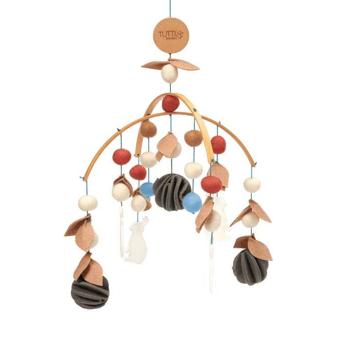 Cutout view of the Cocoon felt nursery mobile with wooden arches, hanging felt balls and animal silhouettes in soft neutral tones