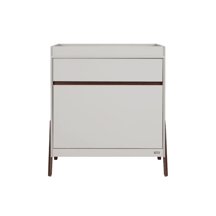 Front cutout of the Fuori chest changer in white sand and warm walnut, showcasing clean lines, integrated handle detail, and warm walnut legs