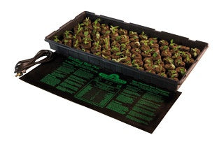 An indoor gardening tray known as TAS Germination Station designed for seed starting. This Germination Station with Heat Mat, 72-Cell Pack, 2" Dome provides the perfect environment for germinating seeds, with a collection of plants placed on top to create a beautiful display.