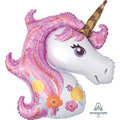 A large, glittery pink unicorn-shaped balloon with floral details and a golden horn.