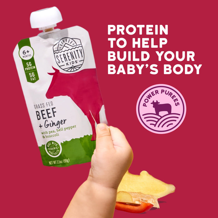Serenity Kids Beef and Ginger protein pouch with a hand holding it against a red background