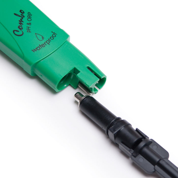 A TAS waterproof green HANNA WATERPROOF ORP/PH/TEMPERATURE TESTER with a black plug attached to it for automatic temperature compensation.