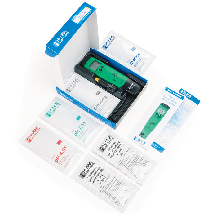 A green box with several items in it, including a TAS HANNA WATERPROOF ORP/PH/TEMPERATURE TESTER.