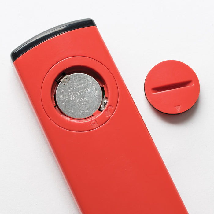 A red TAS remote control next to a button for water quality.