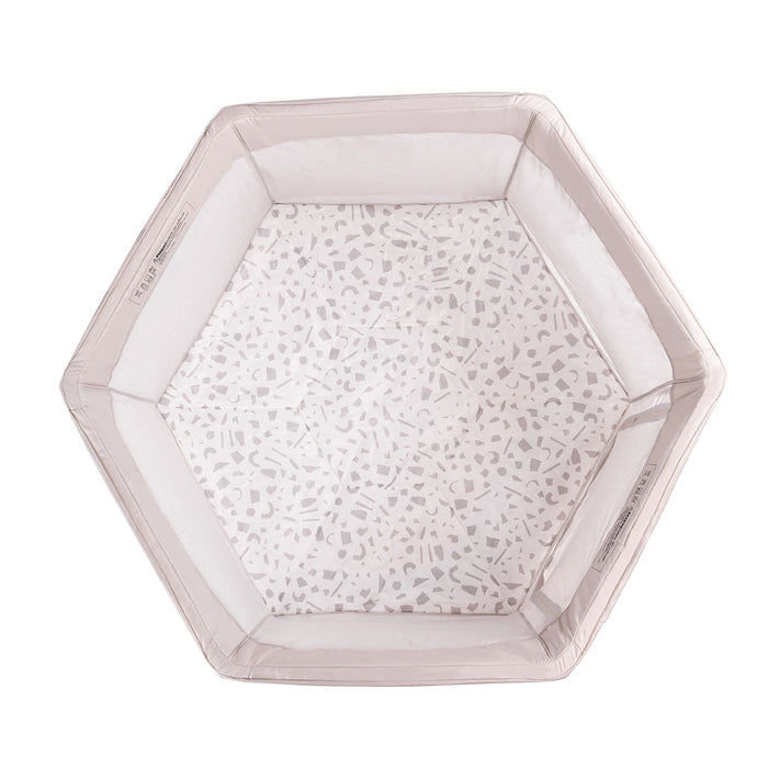 Overhead view of the Hexa Playpen in Mushroom Terrazzo, showing soft padded base with playful terrazzo pattern and mesh sides
