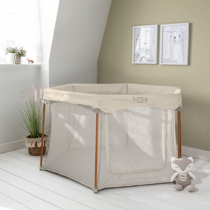 Front view of the Hexa playpen in ecru with breathable mesh panels and sturdy frame, designed to create a safe, comfortable play area at home