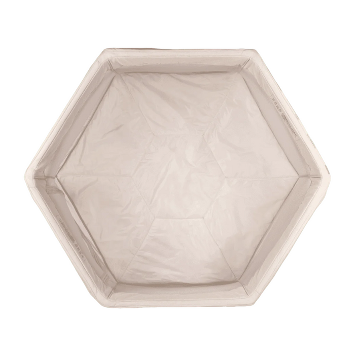 Aerial cutout view of the Hexa playpen in ecru, showcasing the padded hexagonal base and breathable mesh sides